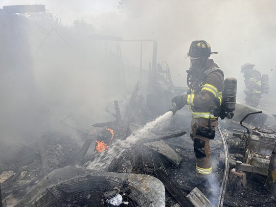 Metal outbuilding catches fire behind Gainesville home